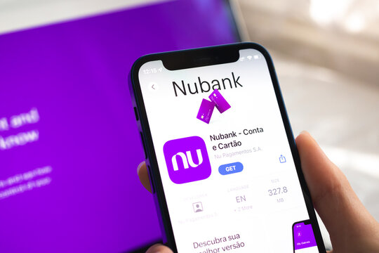 Nubank app icon. Hand with mobile phone with application. Mobile banking concept photo