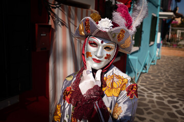 Venice Carnival - Festival in 2022, Murano - person wearing a festival mask, photo taken with flash