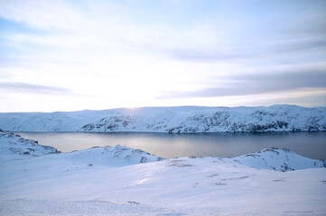 Fototapeta na wymiar Fjord in in mystic pink in winter