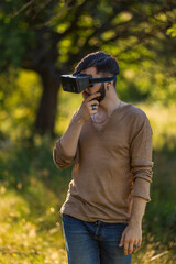 man wearing virtual reality glasses outdoors