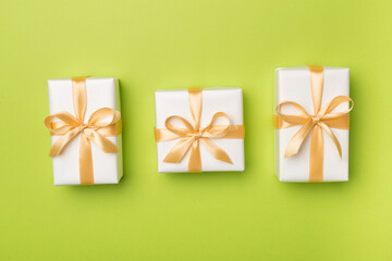 White gift boxes on color background, top view