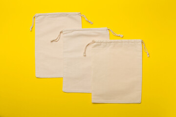 Small eco sacks on color background. Top view