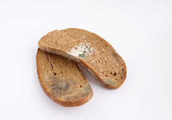 Slices of stale bread with mildew. Moldy fungus on spoiled bread. Food waste