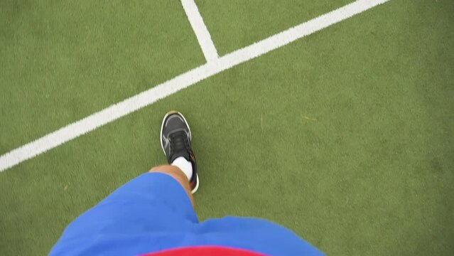 Sportsman legs POV view, handheld shot. Player athlete goes out of the playing field, stadium, or tennis court.