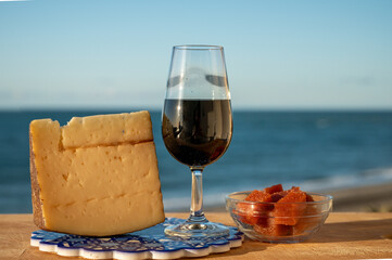 Tasting of sweet Spanish fortified Pedro Ximenez sherry wine with manchego cheese made with same sherry wine in El Puerto de Santa Maria, Andalusia, Spain