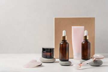 Cosmetic cream, serums, roller and gouache for skin care. Beauty box and cosmetics set on light...