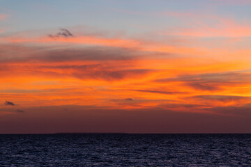 Beautiful view of the sea and the sky in the clouds at sunset. Orange red dawn, dusk on the sea coast