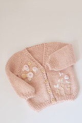 Knitted kids clothes and accessories for knitting. Needlework and knitting. Hobbies and creativity. Knit for children. Handmade. Hobbies and creativity. Sweater with embroidery