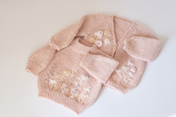 Knitted kids clothes and accessories for knitting. Needlework and knitting. Hobbies and creativity. Knit for children. Handmade. Hobbies and creativity. Sweater with embroidery