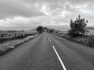 Cloud and rain on, Thick Hollins Road, with hills in the distance near, Meltham, Holmfirth, UK   Black and White