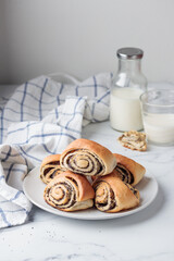 Sweet homemade poppy seed buns with milk for the breakfast