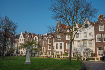 Fototapeta na wymiar Amsterdam, Netherlands, March 2022. The beguinage in Amsterdam with historic facades.