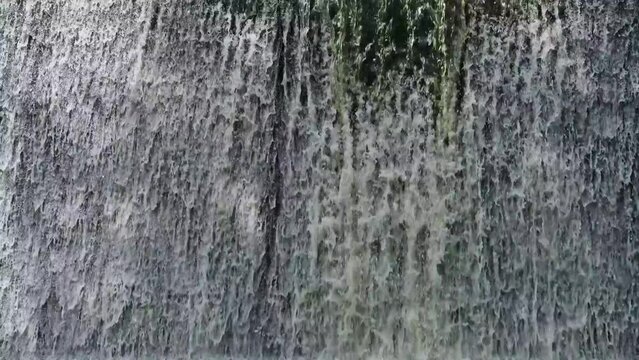 Artificial shaded waterfall on dam on Hirskyi Tikych river, Buky Canyon, Cherkasy Region, Ukraine.
