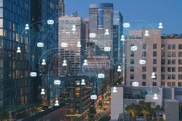 Illuminated cityscape of Los Angeles downtown at night, California, USA. Skyscrapers of LA city. Glowing Social media icons. The concept of networking and establishing new connections between people