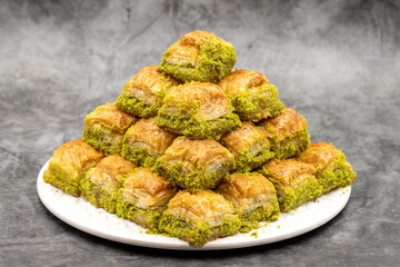 Pistachio baklava dessert on a dark background. Traditional Turkish cuisine delicacies. Close-up Pistachio Baklava. local name kuru baklava