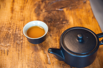 Cup and tea set with tea on table