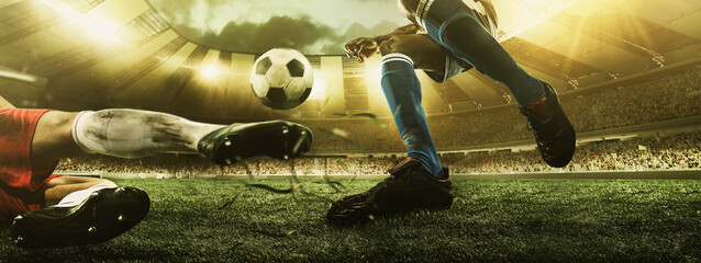Close-up legs of soccer, football players in action, motion at the stadium with flashlights and...