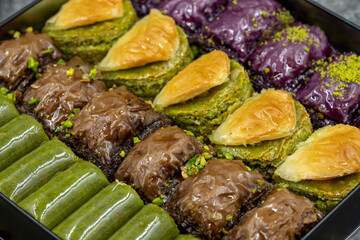 Pistachio baklava. Varieties of baklava with pistachio in a tray. Traditional Turkish cuisine delicacies. Close-up baklava background.
