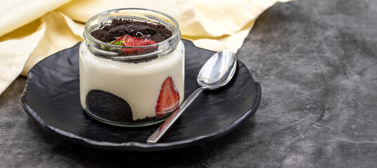 Biscuit and strawberry magnolia dessert on dark background. World cuisine delicacies. close up....