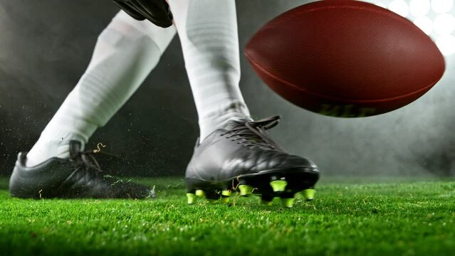 Super slow motion of American football player kicking the ball. Filmed on high speed cinema camera, 1000fps.