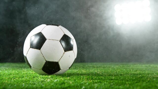 Super slow motion of soccer ball on grass with smoke and rain. Filmed on high speed cinema camera, 1000fps.