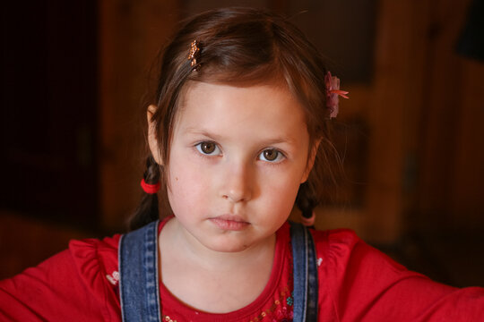 Portrait of a young five year old girl with expressive eyes and pure innocence. A portrait of a little girl with a serious expression on her face