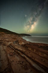 astronomy milky way on the clear sky with rock pattern foreground in Australia. 