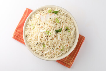 Coconut Rice is a popular South Indian food, served in a ceramic bowl. selective focus