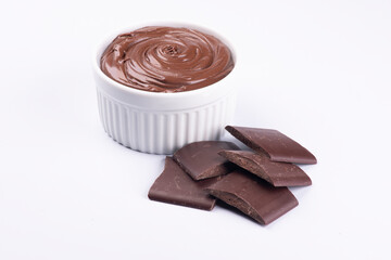 chocolate cream with hazelnuts and chocolate pieces angle view close-up isolated on white background