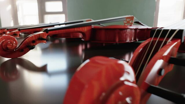 Workshop with ready-made musical instruments - Violins on the table in a row. High Definition Footage for Music Store in Full HD, Looped endless video.