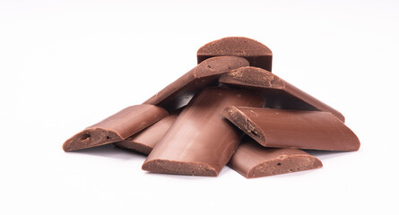 milk chocolate kibbles, pieces front view close up isolated on white background