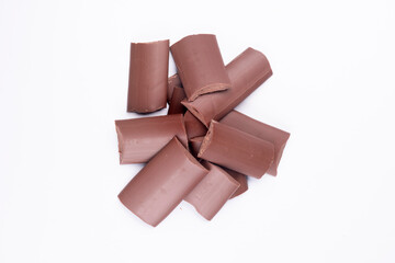 milk chocolate kibbles, pieces top view isolated on white background