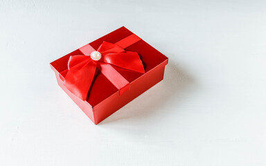 Red gift box on white wooden background
