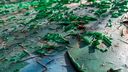 Macro photo of the texture of shabby green paint on a metal surface