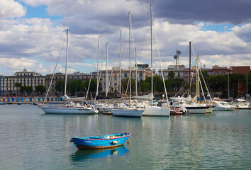 old fishing boat on the background of yachts