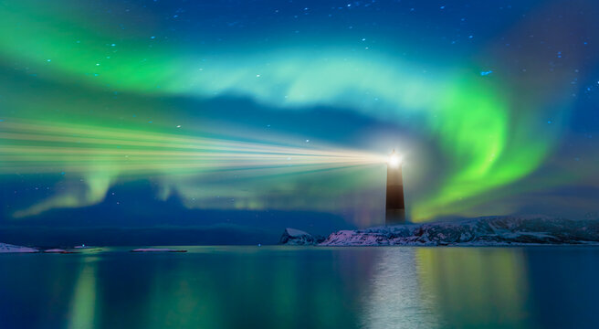 Northern lights (Aurora borealis) over lighthouse seaside in winter