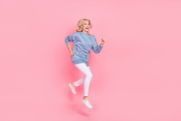 Full body profile side photo of young lovely lady run jump speed hurry motion isolated over pink color background