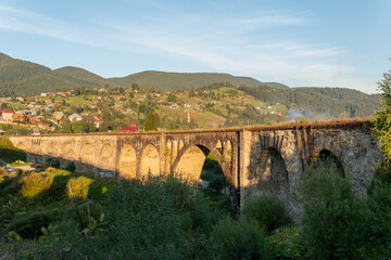 Fototapeta na wymiar A big, old, ancient aqueduct bridge in the mountains