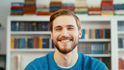 Smiling teacher on the background of books