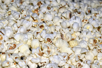 Popcorn in a plastic bag as a background. Close-up