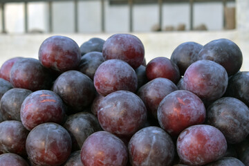 Pile of Fresh Ripe Organic Red Plum Fruits For Sale at the Local Market, Texture background