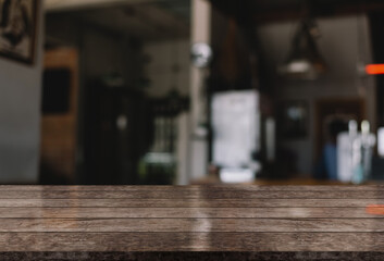 Empty wooden table top with lights bokeh on blur restaurant background.