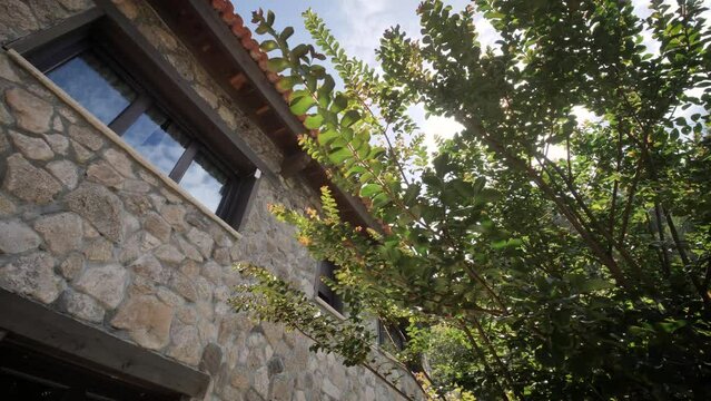 traveling of a residential facade house for vacional turism with rustical stone wall