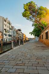 Fototapeta premium Venice, Italy - July 28 2021: Streets of Venice, during sunrise