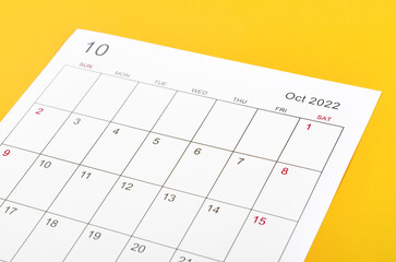 October 2022 calendar sheet on yellow background.