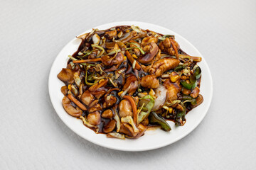 Fototapeta na wymiar closeup of chop suey with chicken typical dish of chinese food on white tablecloth