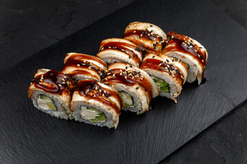 Japanese cuisine. Rolls on a dark concrete background
