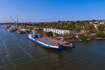 Obraz premium Nikopol river port from above. Photo of barges in the water. Summer sunny day.