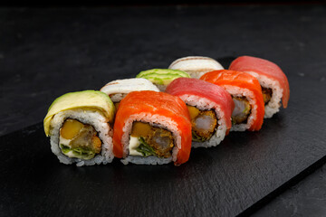Japanese cuisine. Rolls on a dark concrete background
