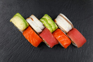 Japanese cuisine. Rolls on a dark concrete background

